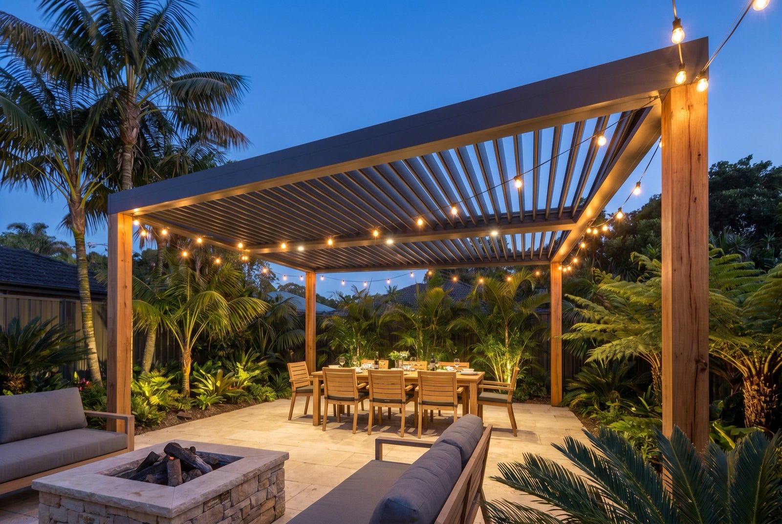 Outdoor entertaining area with pergola, dining setting and festoon lights